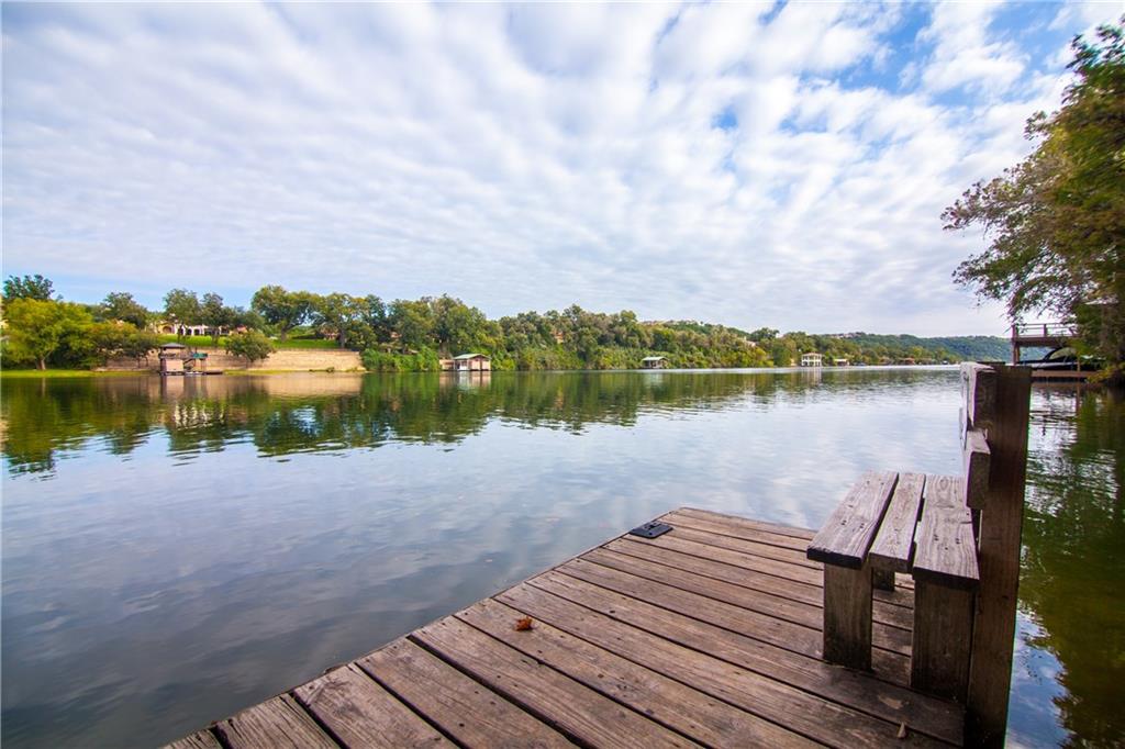 Apache Shores community day dock reaching into Lake Austin with Hill Country homes across the water
